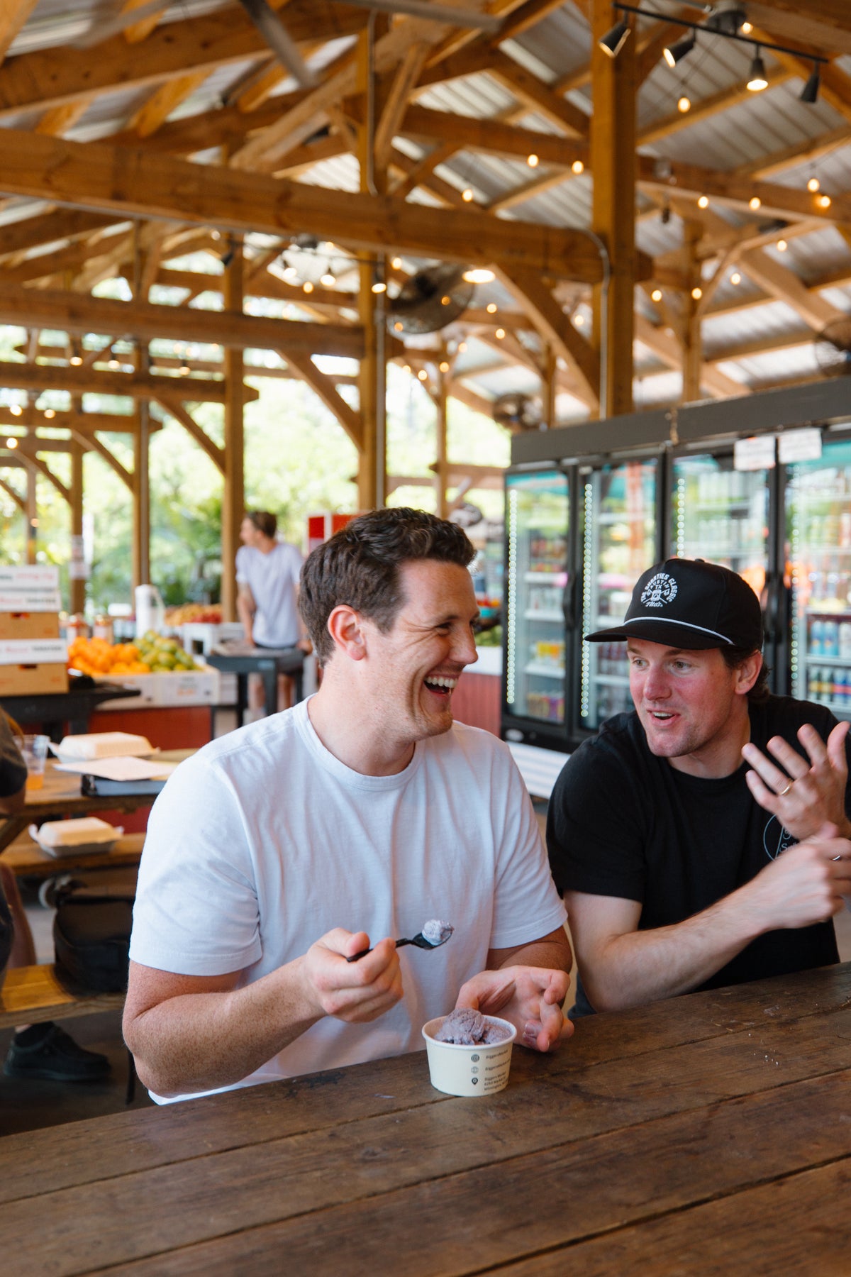 Friends sharing a meal while local musicians play at the market